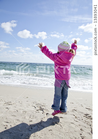 Cute young girl having fun on the beach Cute young girl having fun on the beach 13893041