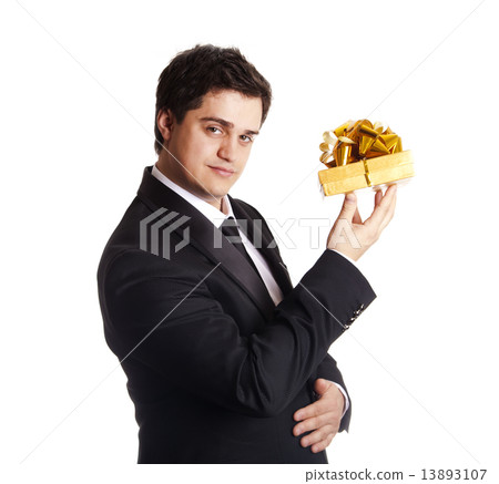 A man holding present box in formal black tux A man holding present box in formal black tux 13893107