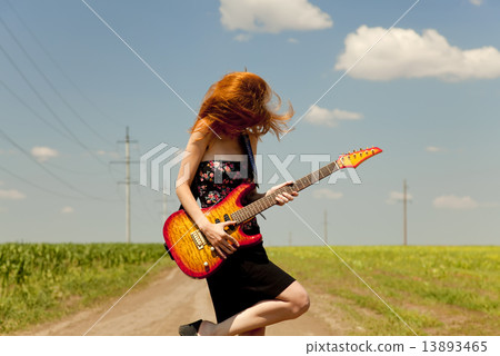 Rock girl with guitar at countryside. Rock girl with guitar at countryside. 13893465