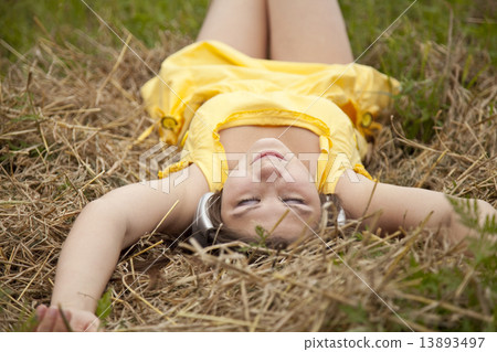 Young beautiful girl in yellow with headphones at field. Young beautiful girl in yellow with headphones at field. 13893497