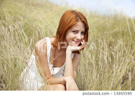 Beautiful red-haired girl at grass 13893590