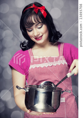 Brunette housewife with soup ladle Brunette housewife with soup ladle 13893708