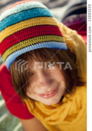 Close-up view at teen girl in rasta cap. 13893839