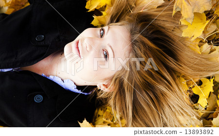Smiling happy girl in autumn park 13893892