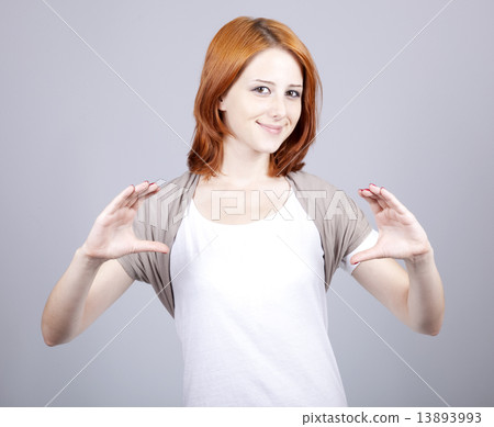 Red-haired businesswoman show something in air. 13893993