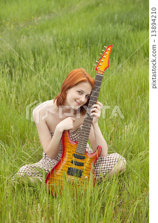 Girl with guitar at green grass Girl with guitar at green grass 13894210