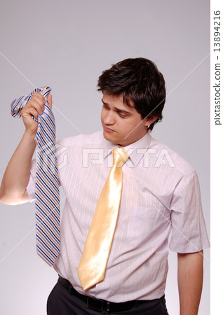 Young men could't select tie. Studio shot. Young men could't select tie. Studio shot. 13894216