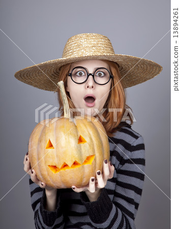 Funny girl in cap showing pumpkin. Funny girl in cap showing pumpkin. 13894261