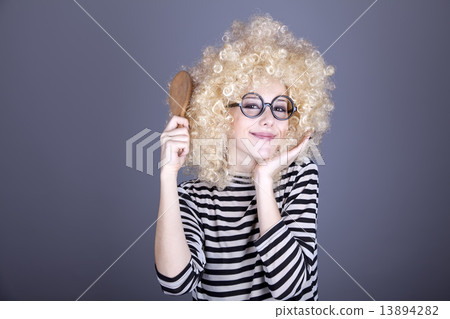 Surprised girl with comb. 13894282