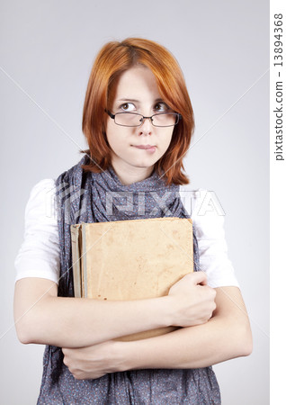 Young doubting fashion girl in glasses with old book 13894368