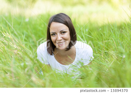 Beautiful teen girl in the park at green grass. 13894370