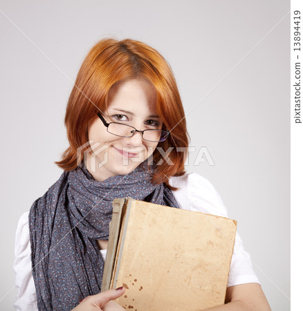 Young smiling fashion girl in glasses with old book 13894419