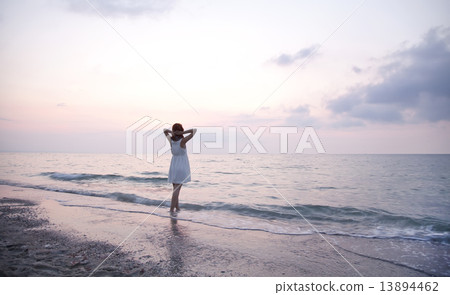 Young beautiful girl on the beach at sunrise Young beautiful girl on the beach at sunrise 13894462