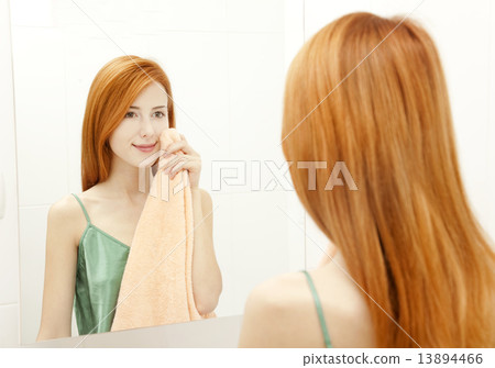Beautiful redhead young woman with fresh skin of face in bathroo Beautiful redhead young woman with fresh skin of face in bathroo 13894466