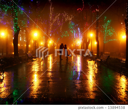 Couple walking at alley in night lights. Photo in vintage style. 13894538