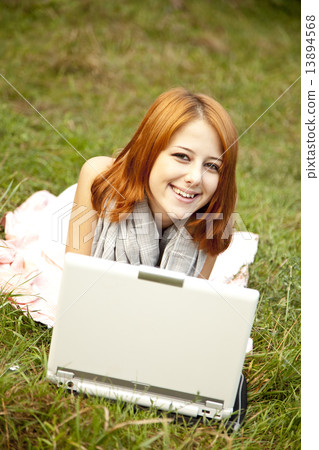 Young fashion girl with notebook lying at green grass Young fashion girl with notebook lying at green grass 13894568