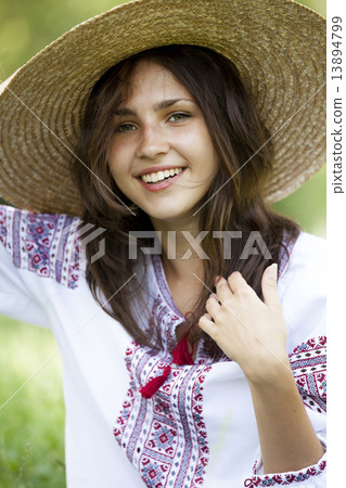 Slav teen girl at green meadow in national ukrainian clothing. Slav teen girl at green meadow in national ukrainian clothing. 13894799