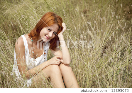 Beautiful red-haired girl at grass 13895073