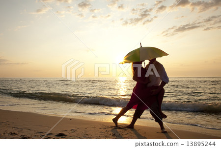 Couple kissing at the beach in sunset. Couple kissing at the beach in sunset. 13895244