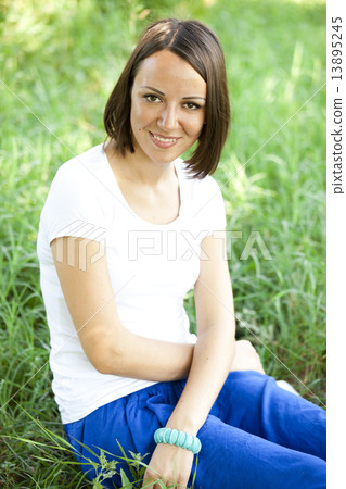 Beautiful teen girl in the park at green grass. Beautiful teen girl in the park at green grass. 13895245