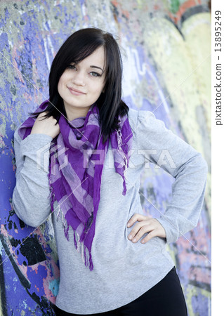 Teen girl near graffiti wall Teen girl near graffiti wall 13895249