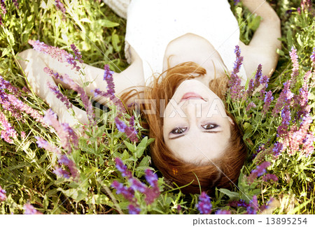 Redhead girl in purple flowers. 13895254