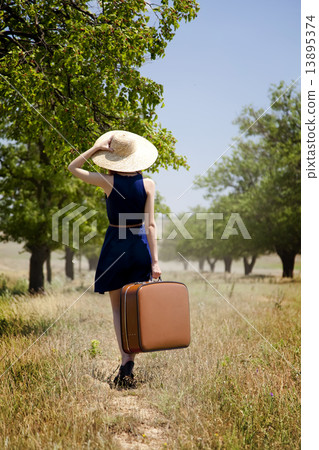 Lonely girl with suitcase at countryside. 13895374