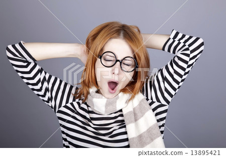 Sleeping red-haired girl in glasses and scarf. Sleeping red-haired girl in glasses and scarf. 13895421