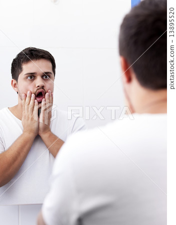 Surprised men near mirror. Surprised men near mirror. 13895520