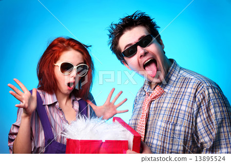 Fashion boy presenting a gift to girl 13895524