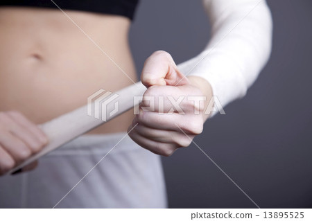 Strong girl's body with with elastic bandage on hand. Strong girl's body with with elastic bandage on hand. 13895525