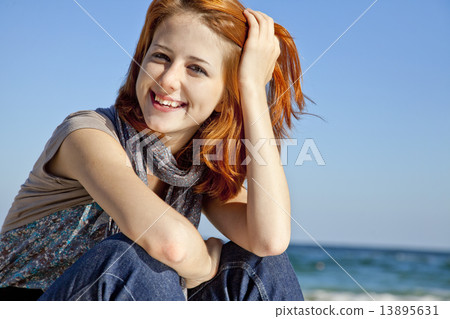 Portrait of happy red-haired girl on the beach. Portrait of happy red-haired girl on the beach. 13895631