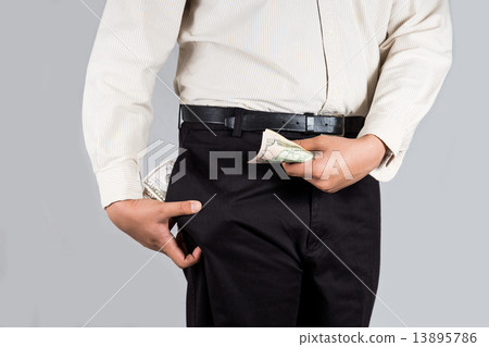 Man with abundant of money in his pockets holding some money 13895786