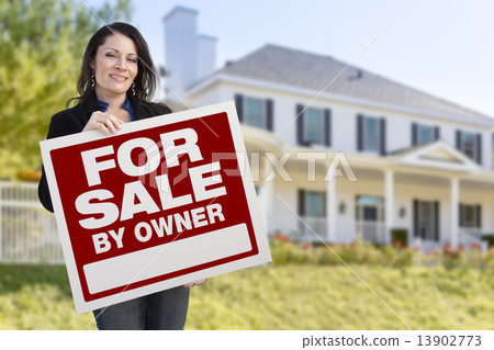 Stock Photo: Female Holding Sale By Owner Sign In Front of House