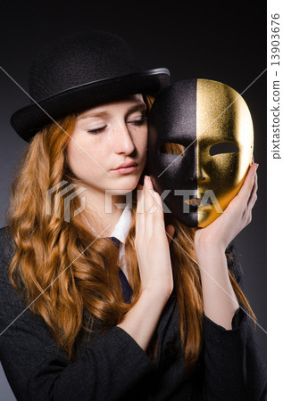 Woman with mask in hypocrisy concept 13903676
