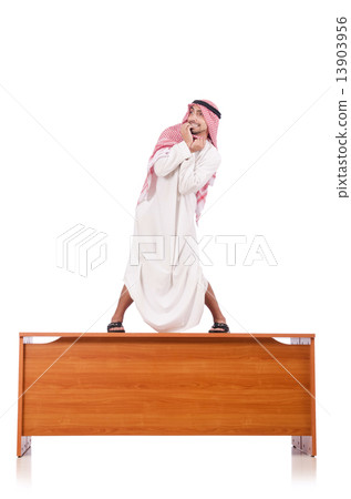Arab man sitting at his desk 13903956