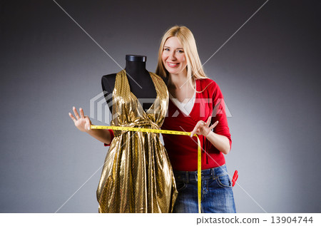 Woman tailor working on clothing 13904744