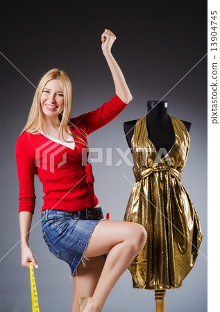 Woman tailor working on clothing 13904745