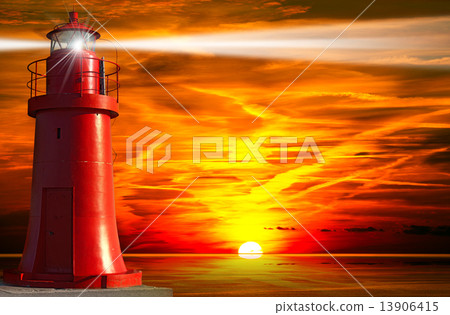 Red Lighthouse with Light Beam at Sunset 13906415