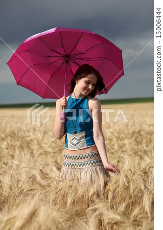 Girl with umbrella at field. Girl with umbrella at field. 13906444