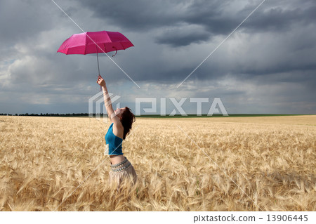Girl with umbrella at field. 13906445