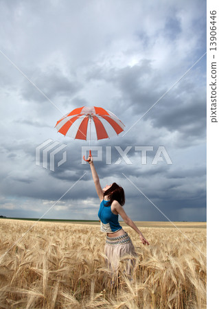 Girl with umbrella at field. Girl with umbrella at field. 13906446