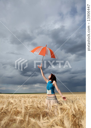 Girl with umbrella at field. Girl with umbrella at field. 13906447