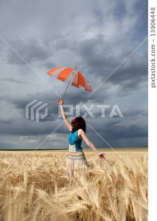 Girl with umbrella at field. Girl with umbrella at field. 13906448