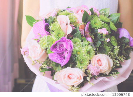 Bride or bridemaid with bouquet of flower, retro filter effect Bride or bridemaid with bouquet of flower, retro filter effect 13906748
