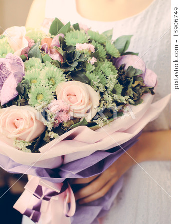 Bride or bridemaid with bouquet of flower, retro filter effect Bride or bridemaid with bouquet of flower, retro filter effect 13906749