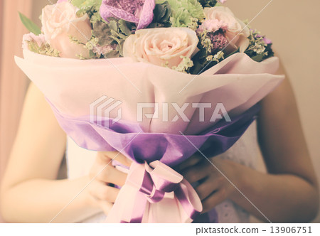 Bride or bridemaid with bouquet of flower, retro filter effect 13906751
