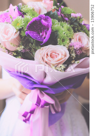 Bride or bridemaid with bouquet of flower, retro filter effect Bride or bridemaid with bouquet of flower, retro filter effect 13906752
