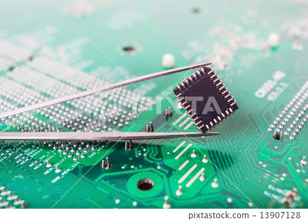 microchip in the tweezers closeup 13907128