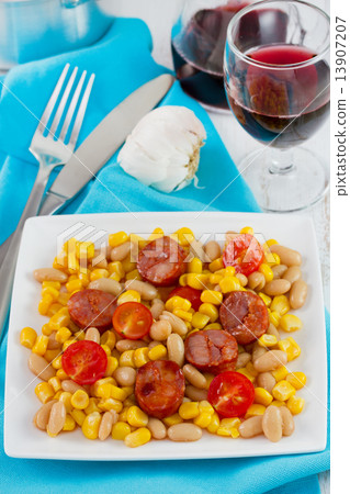 fried sausages with corn and beans on the plate and glass of red glass fried sausages with corn and beans on the plate and glass of red glass 13907207